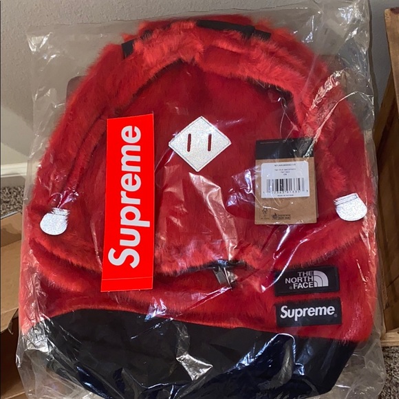 Red Supreme X The North Face faux fur back pack.